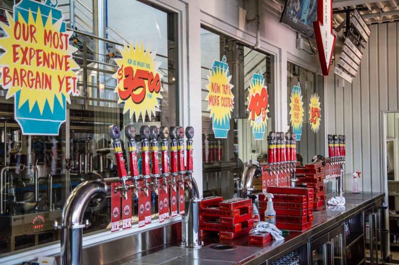 Red Truck Beer $100 six pack signs behind the bar